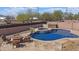 Backyard pool with a baja deck, hot tub, and nearby fire pit with chairs at 11183 W Tonto St, Avondale, AZ 85323