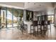 Entertainer's bar featuring modern bar stools, granite counters, and a large sliding glass door to outdoor patio at 11935 E Casitas Del Rio Dr, Scottsdale, AZ 85255