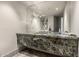 Elegant bathroom with green marble vanity and a decorative mirror, creating a serene spa-like ambiance at 11935 E Casitas Del Rio Dr, Scottsdale, AZ 85255