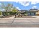 Desert home with native landscaping, a wide driveway, and attached garages at 11935 E Casitas Del Rio Dr, Scottsdale, AZ 85255