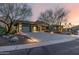 Modern home with a large driveway and desert landscaping at dusk at 11935 E Casitas Del Rio Dr, Scottsdale, AZ 85255