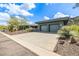Contemporary home with a paver driveway, desert landscaping, and an attached two-car garage at 11935 E Casitas Del Rio Dr, Scottsdale, AZ 85255