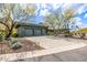 Desert home with native landscaping, a wide driveway, and attached garages at 11935 E Casitas Del Rio Dr, Scottsdale, AZ 85255