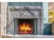 Grand outdoor fireplace featuring a stone surround with roaring flames at 11935 E Casitas Del Rio Dr, Scottsdale, AZ 85255