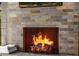 Cozy stone fireplace with a live flame, perfect for creating a warm ambiance at 11935 E Casitas Del Rio Dr, Scottsdale, AZ 85255