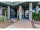 Inviting front entrance showcasing stone accents, desert landscaping, and modern glass door at 11935 E Casitas Del Rio Dr, Scottsdale, AZ 85255