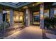An inviting front entrance with desert landscaping, stone accents, and a modern glass door at 11935 E Casitas Del Rio Dr, Scottsdale, AZ 85255