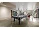 Spacious game room with a pool table, high ceilings, and access to an outdoor patio at 11935 E Casitas Del Rio Dr, Scottsdale, AZ 85255