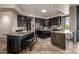 Spacious kitchen with dark cabinets, multiple islands, granite counters and tile flooring at 11935 E Casitas Del Rio Dr, Scottsdale, AZ 85255