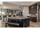 Kitchen island with seating and cabinets with granite countertops and open floorplan at 11935 E Casitas Del Rio Dr, Scottsdale, AZ 85255