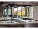 Modern kitchen cooktop with glass backsplash overlooking outdoor desert views at 11935 E Casitas Del Rio Dr, Scottsdale, AZ 85255