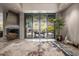 Spacious living area with sleek fireplace and seamless indoor-outdoor flow via large sliding glass doors at 11935 E Casitas Del Rio Dr, Scottsdale, AZ 85255