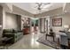 Inviting living room with modern ceiling fan, comfortable sofas, and stylish decor at 11935 E Casitas Del Rio Dr, Scottsdale, AZ 85255
