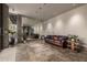 Bright living room with tile floors, large mirror wall and comfortable seating with modern pendant lighting at 11935 E Casitas Del Rio Dr, Scottsdale, AZ 85255