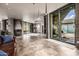 Open floor plan with fireplace, tile flooring, floor-to-ceiling windows, and outdoor access to a patio at 11935 E Casitas Del Rio Dr, Scottsdale, AZ 85255