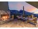 Outdoor fireplace surrounded by comfortable seating and mountain views at 11935 E Casitas Del Rio Dr, Scottsdale, AZ 85255