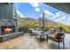 Outdoor patio with fireplace and scenic mountain views at 11935 E Casitas Del Rio Dr, Scottsdale, AZ 85255