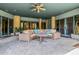 Inviting outdoor seating area with ceiling fan and decorative stone at 11935 E Casitas Del Rio Dr, Scottsdale, AZ 85255