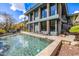 A luxurious pool sits in front of a modern home with views of surrounding desert landscape at 11935 E Casitas Del Rio Dr, Scottsdale, AZ 85255
