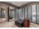 Spacious walk-in closet featuring ample storage with mirrored doors, frosted glass doors, and built-in shelving at 11935 E Casitas Del Rio Dr, Scottsdale, AZ 85255