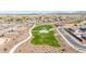 Community aerial view showcasing park, green space, walking path, and desert landscape against a mountain backdrop at 1316 E Spencer St, Casa Grande, AZ 85122