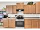 Well-organized kitchen featuring wooden cabinets and a stainless steel oven, with ample counter space and a sleek design at 1316 E Spencer St, Casa Grande, AZ 85122