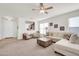 Bright living room featuring neutral paint, carpet, and access to the kitchen through a passthrough at 1316 E Spencer St, Casa Grande, AZ 85122