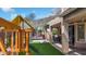 Inviting backyard with a playground, covered patio with string lights, and a trampoline for outdoor fun at 13637 W Port Royale Ln, Surprise, AZ 85379
