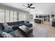 Bright and airy living room featuring large windows, an area rug and an adjacent dining area at 13637 W Port Royale Ln, Surprise, AZ 85379