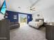 Bright primary bedroom featuring a ceiling fan and a sliding glass door to the backyard at 13637 W Port Royale Ln, Surprise, AZ 85379