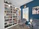Cozy home office with built-in bookshelves, soft chair, and natural light at 13637 W Port Royale Ln, Surprise, AZ 85379