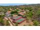 Aerial view of the community featuring tennis courts, lush landscaping, and red tile roofs at 1405 W Caribbean Ln, Phoenix, AZ 85023