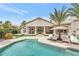 Resort-style backyard featuring a swimming pool, manicured landscaping, and covered patio at 1405 W Caribbean Ln, Phoenix, AZ 85023