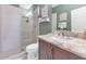 Bathroom features a white vanity, quartz counters, decorative mirror, and a walk-in shower at 1405 W Caribbean Ln, Phoenix, AZ 85023
