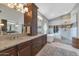 Luxurious bathroom with double sinks, a soaking tub, and a glass-enclosed shower at 1405 W Caribbean Ln, Phoenix, AZ 85023
