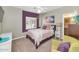 Bright bedroom with closet access features accent wall and comfortable furnishings at 1405 W Caribbean Ln, Phoenix, AZ 85023