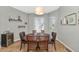 Dining room with a round table set beneath an elegant pendant light fixture at 1405 W Caribbean Ln, Phoenix, AZ 85023