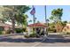 Coral Gables Estates entrance featuring a guard house with tile roof and manicured landscaping at 1405 W Caribbean Ln, Phoenix, AZ 85023
