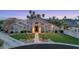 Charming home featuring a well-manicured lawn, mature trees, and inviting entrance at dusk at 1405 W Caribbean Ln, Phoenix, AZ 85023