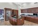 Gourmet kitchen featuring stainless steel appliances, dark wood cabinetry, and a center island at 1405 W Caribbean Ln, Phoenix, AZ 85023