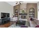 Inviting living room with a cozy fireplace and lots of natural light at 1405 W Caribbean Ln, Phoenix, AZ 85023
