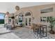 Covered outdoor living space features tile flooring, arched windows, outdoor dining and seating at 1405 W Caribbean Ln, Phoenix, AZ 85023