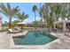 Sparkling pool with lounge chairs, desert landscaping, custom tile accents, and outdoor bar area at 1405 W Caribbean Ln, Phoenix, AZ 85023