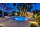 Backyard featuring a sparkling pool, lounge chairs, modern outdoor kitchen and tropical landscaping at 1405 W Caribbean Ln, Phoenix, AZ 85023