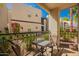 Private balcony with iron railings, views of the community, and a small table set with chairs at 14145 N 92Nd St # 1158, Scottsdale, AZ 85260
