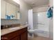 Bright bathroom showcasing a shower over bath, a granite countertop, and towel racks at 14145 N 92Nd St # 1158, Scottsdale, AZ 85260