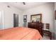 Bedroom featuring dresser, mirror, and doors to bathroom and closet at 14145 N 92Nd St # 1158, Scottsdale, AZ 85260