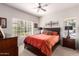 Cozy bedroom showcasing a ceiling fan and large window for natural light at 14145 N 92Nd St # 1158, Scottsdale, AZ 85260