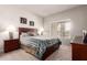 Bedroom with blue accents and neutral walls, featuring large window and a ceiling fan at 14145 N 92Nd St # 1158, Scottsdale, AZ 85260