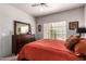 Relaxing bedroom with a large window and a dark wood dresser with mirror at 14145 N 92Nd St # 1158, Scottsdale, AZ 85260